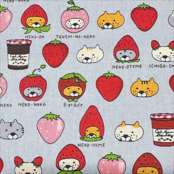 Close up of Strawberry Cats canvas fabric by Cotton Kobayashi, cotton linen blend with playful cats dressed as strawberries