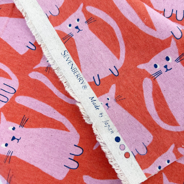 Selvage of Stray Cat Friends Cotton Linen Canvas fabric by Sevenberry, style 850615, in coral and pink