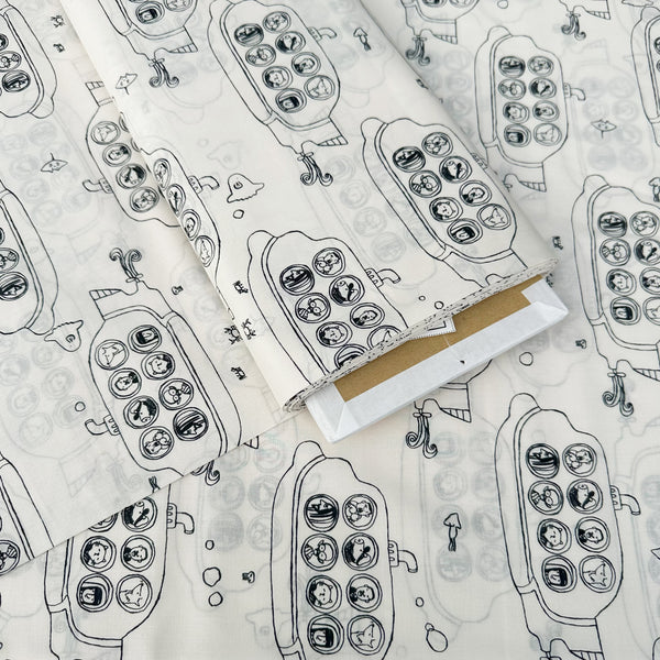 Bolt of Submarine cotton lawn fabric by Hokkoh in natural, featuring black submarines