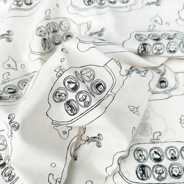 Drape of Submarine cotton lawn fabric by Hokkoh in natural, featuring black submarines