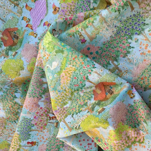 Drape of Sweet Farm Cotton Lawn Fabric in Blue by Yukiemon for Hokkoh featuring whimsical farm animals and countryside illustrations on soft Japanese cotton lawn.