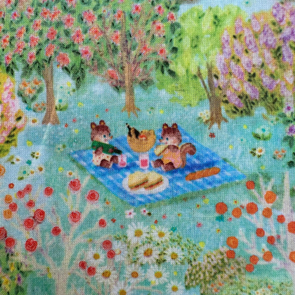 Picnic scene in Sweet Farm Cotton Lawn Fabric in Blue by Yukiemon for Hokkoh featuring whimsical farm animals and countryside illustrations on soft Japanese cotton lawn.