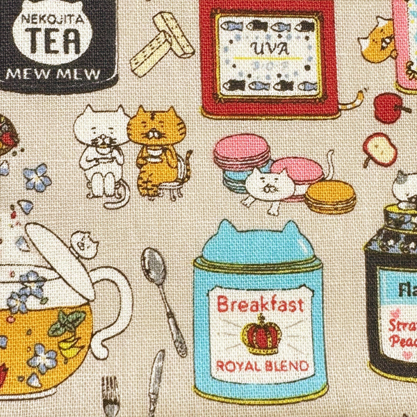 Close up of Tea Cats Canvas Fabric in Beige by Cotton Kobayashi – silly cats playing and drinking tea on cotton linen canvas, imported from Japan