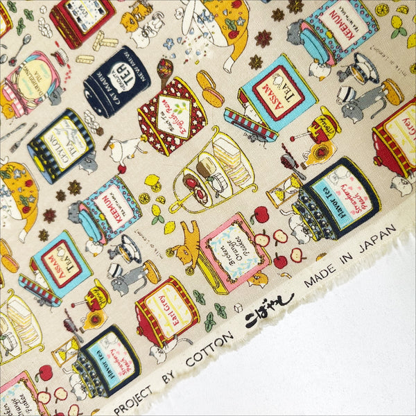 Selvage of Tea Cats Canvas Fabric in Beige by Cotton Kobayashi – silly cats playing and drinking tea on cotton linen canvas, imported from Japan
