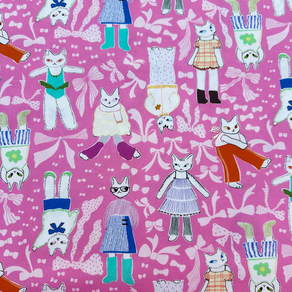 The Open Closet cotton fabric in pink by Nora featuring cats getting dressed in cute outfits with bows imported from Japan