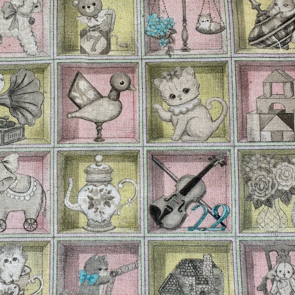 Close up of Toy Night Box cotton linen fabric by Yukiemon for Hokkoh featuring vintage-style toy illustrations arranged in boxes with soft pastel colors, imported from Japan