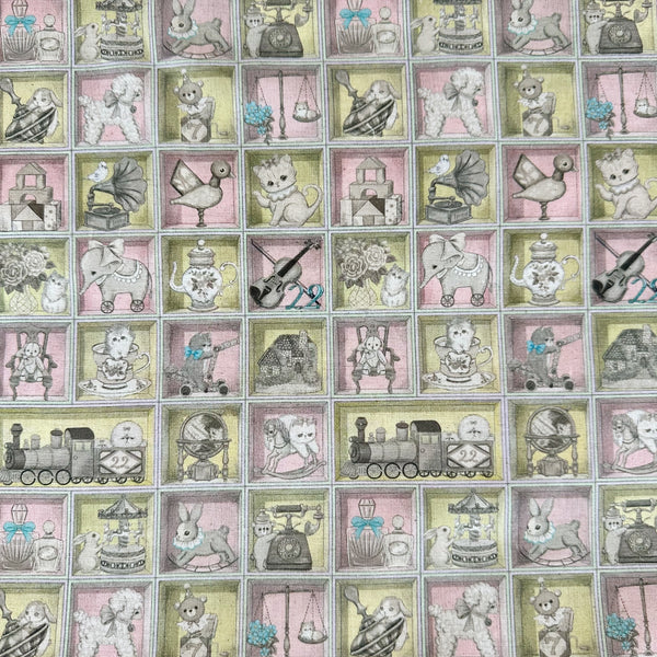 Toy Night Box cotton linen fabric by Yukiemon for Hokkoh featuring vintage-style toy illustrations arranged in boxes with soft pastel colors, imported from Japan