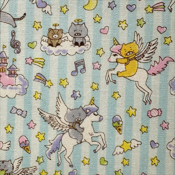 Close up of Unicorn Cats cotton linen blend canvas fabric in light aqua by Cotton Kobayashi featuring whimsical cat and unicorn illustrations