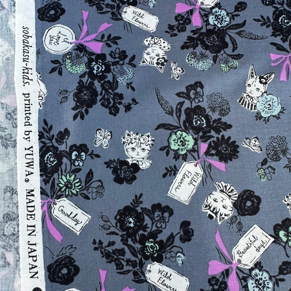 Selvage of Wild Flower Bouquet cotton fabric in Charcoal by Sobakasu Kids for Yuwa Fabrics featuring a detailed floral bouquet print