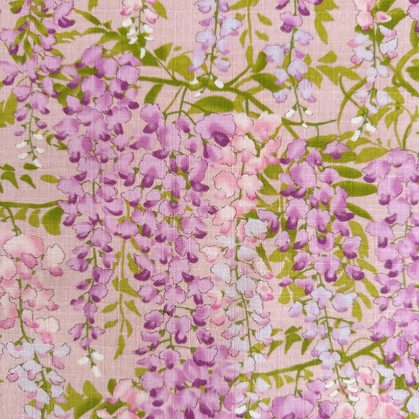 Close up of Wisteria Cotton Dobby Fabric by Cotton Kobayashi, style KTS7191-B, featuring wisteria blossoms, in pink, imported from Japan