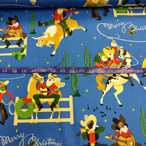 Alexander Henry Giddy Up Santa Cotton Fabric in Blue